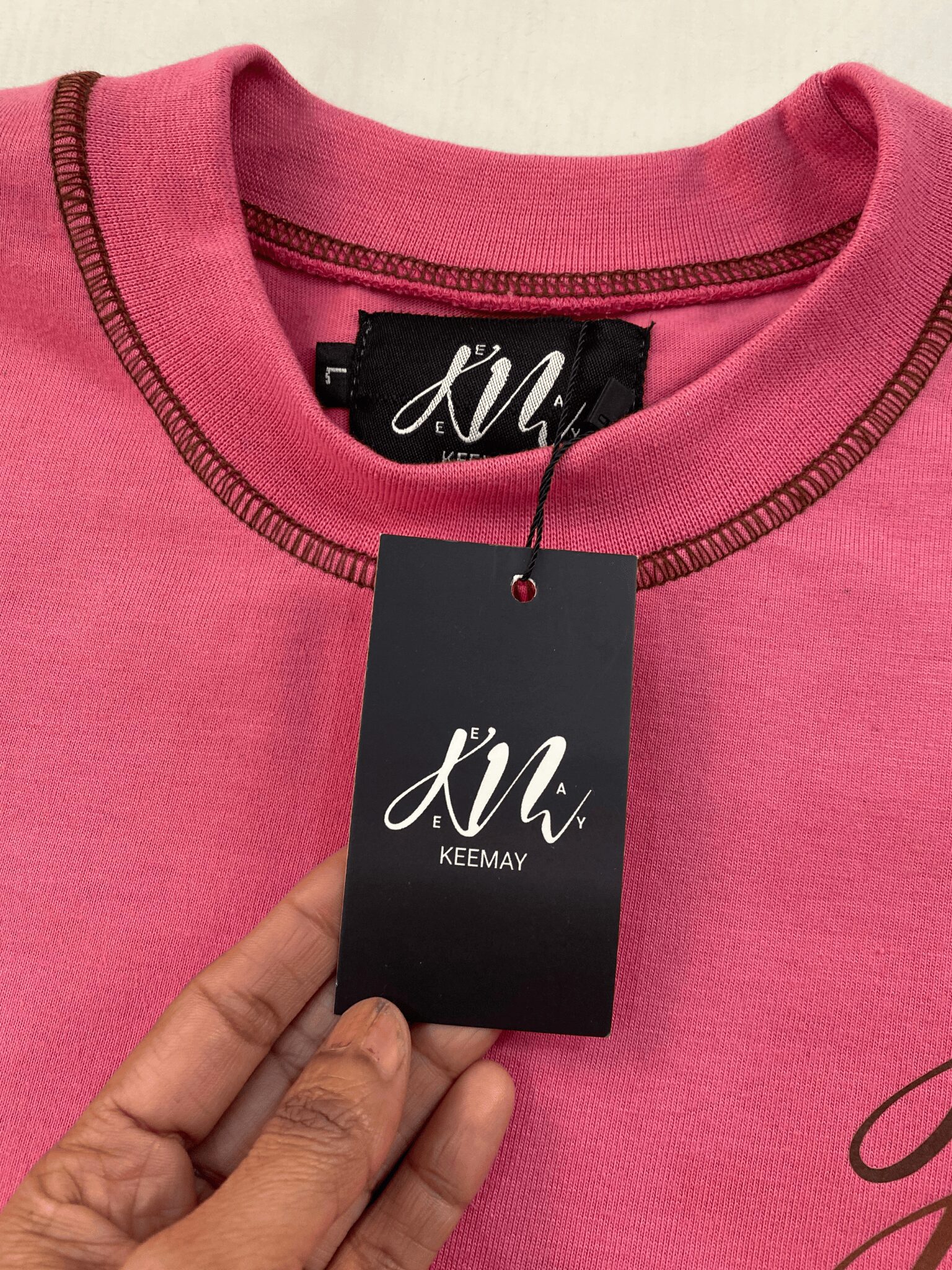 Closeup of custom woven label and hanging tag on t-shirt for private branding